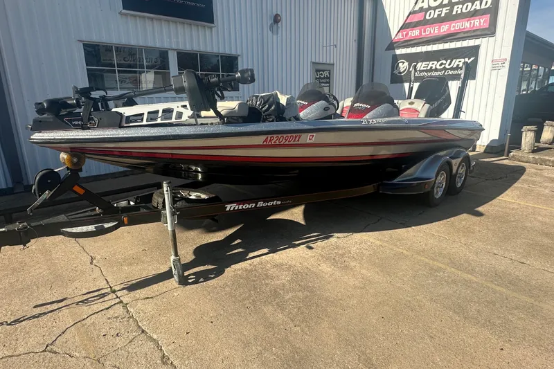 Slide: The Image of 2009 Triton 21X3 Pro DC boat on trailer outside dealership. - 2
