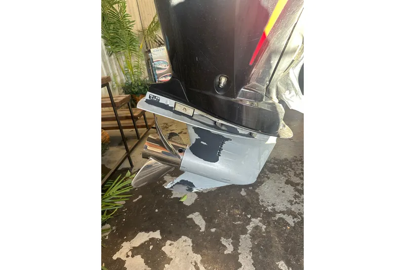 Slide: The Image of 2009 Triton 21X3 Pro DC boat motor with visible wear and propeller. - 20