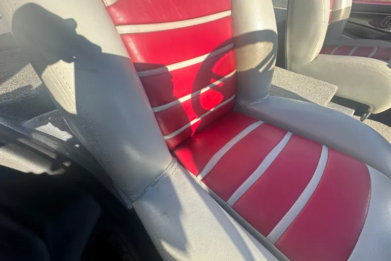 Slide: The Image of 2009 Triton 21X3 Pro DC boat seat with red and gray upholstery. - 9