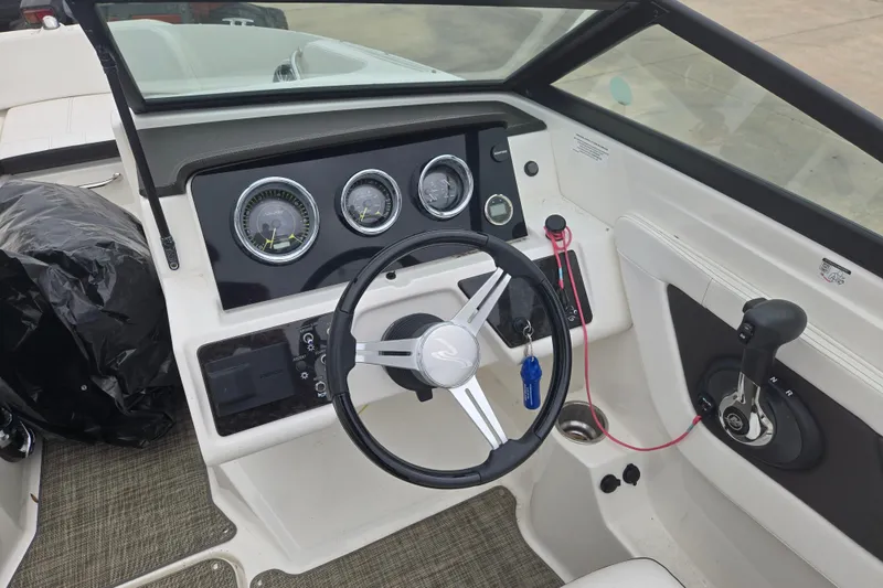 Slide: The Image of 2019 Sea Ray SPX 190 Outboard dashboard with steering wheel and control panel. - 7