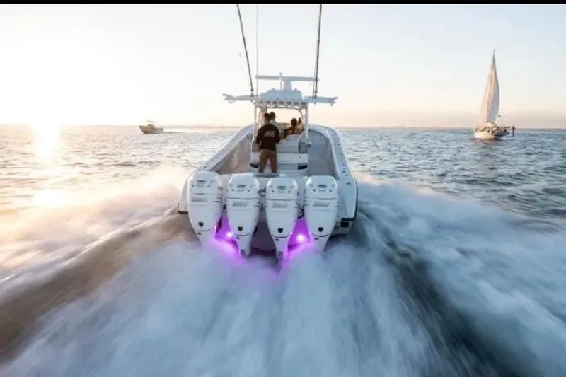 Slide: The Image of 2019 Yellowfin 39 Offshore boat cruising with four powerful engines at sunset. - 10