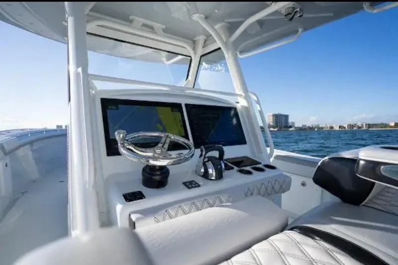 Slide: The Image of 2019 Yellowfin 39 Offshore boat cruising on open water at sunset. - 16