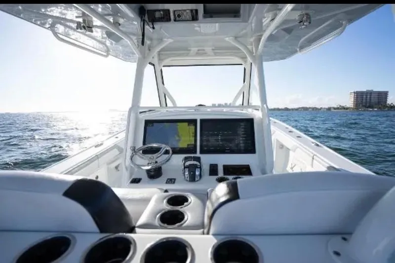 Slide: The Image of 2019 Yellowfin 39 Offshore boat cruising on open water at sunset. - 17