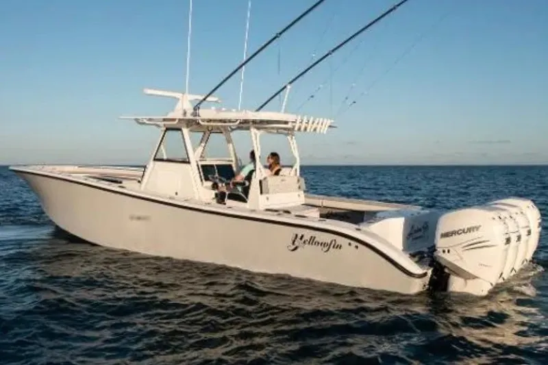 Slide: The Image of 2019 Yellowfin 39 Offshore boat cruising on open water at sunset. - 2