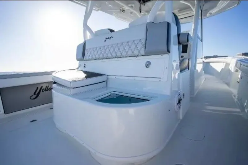 Slide: The Image of 2019 Yellowfin 39 Offshore boat interior with cushioned seating on open water. - 21