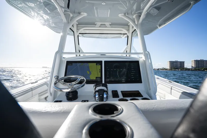 Slide: The Image of 2019 Yellowfin 39 Offshore boat cockpit with navigation screens and steering wheel. - 30