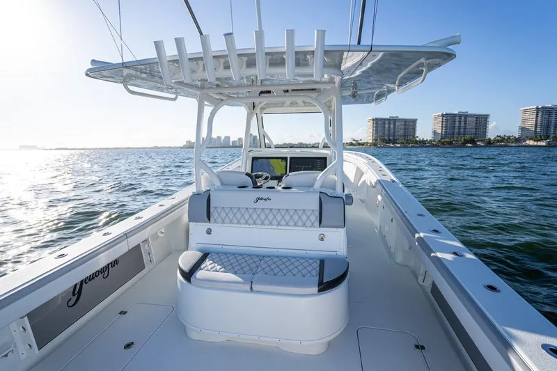 Slide: The Image of 2019 Yellowfin 39 Offshore boat on water, city skyline in background. - 37