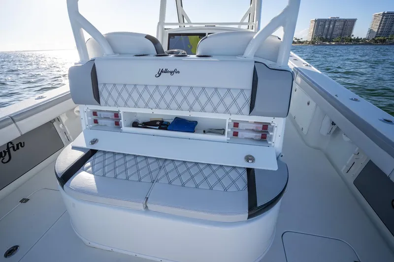Slide: The Image of 2019 Yellowfin 39 Offshore boat interior with storage compartment open, ocean view in background. - 39