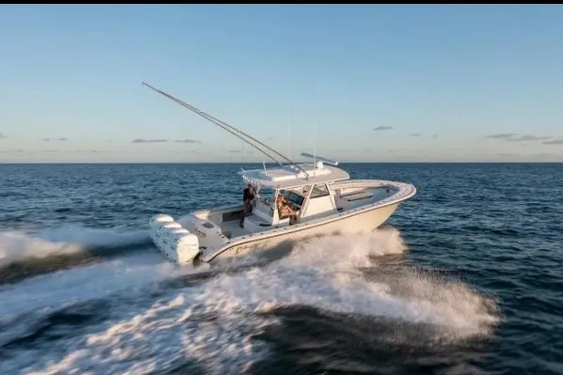 Slide: The Image of 2019 Yellowfin 39 Offshore boat cruising on open water at sunset. - 8