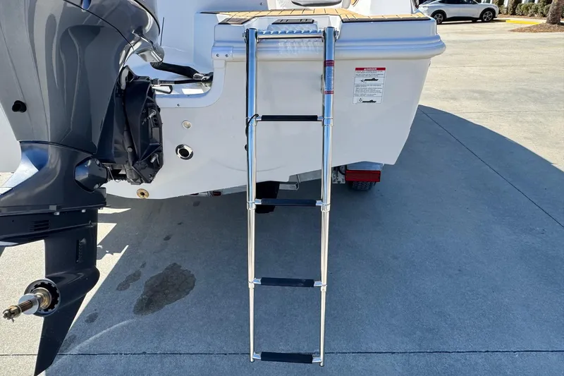 Slide: The Image of Rear view of 2026 Starcraft SVX 171 OB boat with ladder and outboard motor. - 13