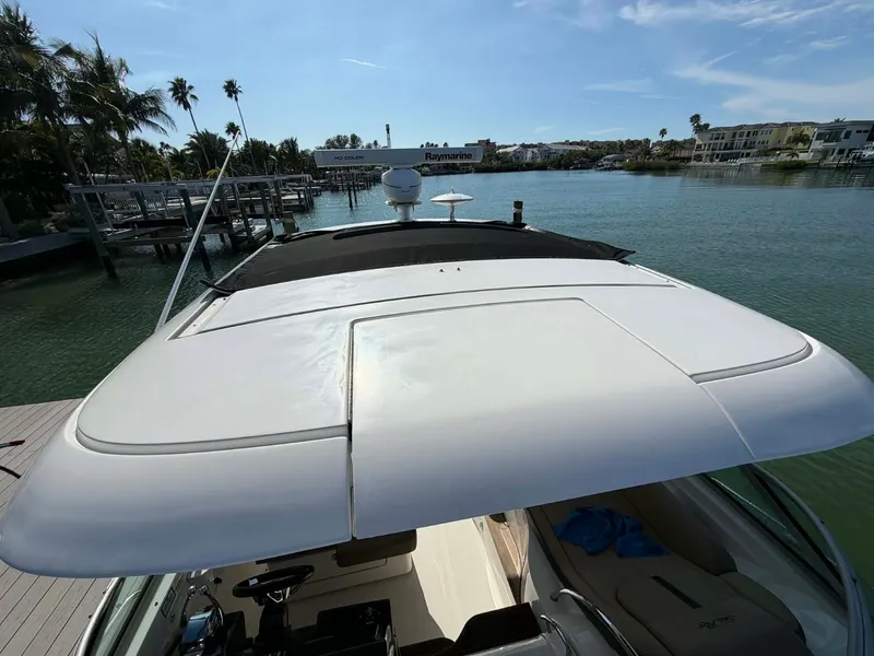 Slide: The Image of 2016 Sea Ray Sundancer 350 on calm water with palm trees in background. - 32