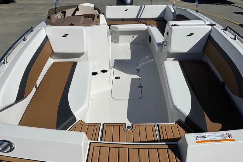 Slide: The Image of Interior of 2026 Starcraft SVX 171 OB boat with brown and white seating. - 11