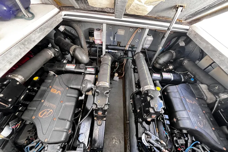 Slide: The Image of Engine compartment of a 1999 Sea Ray 380 Sundancer with dual V8 engines. - 14