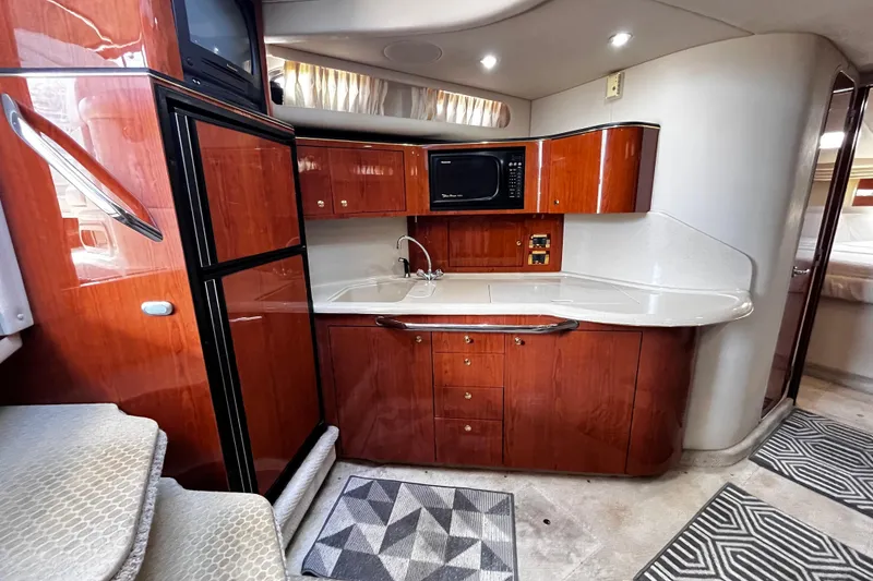 Slide: The Image of Luxurious 1999 Sea Ray 380 Sundancer yacht interior with modern kitchen amenities. - 19