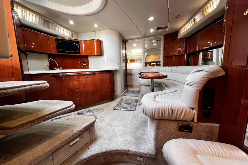 Slide: The Image of Luxurious interior of 1999 Sea Ray 380 Sundancer yacht with plush seating and modern kitchen. - 20