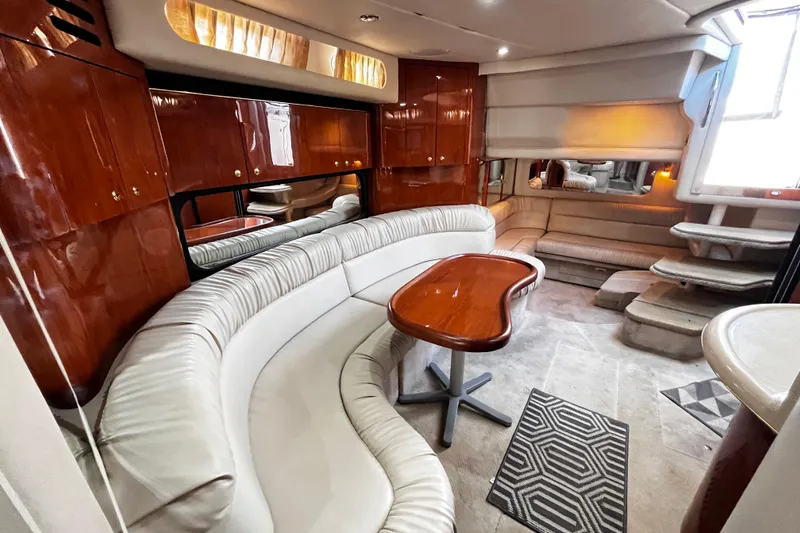 Slide: The Image of Luxurious interior of 1999 Sea Ray 380 Sundancer yacht with elegant seating and wooden accents. - 21