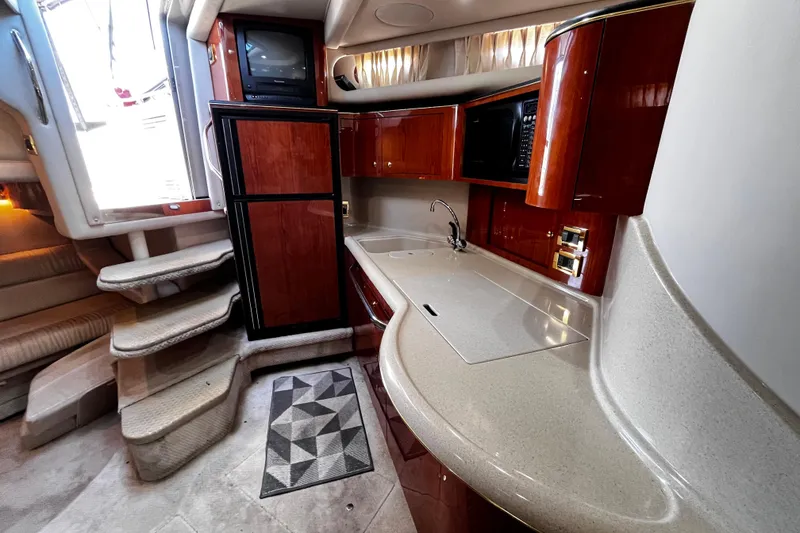 Slide: The Image of Luxurious 1999 Sea Ray 380 Sundancer yacht interior with modern kitchen and elegant wood finishes. - 23