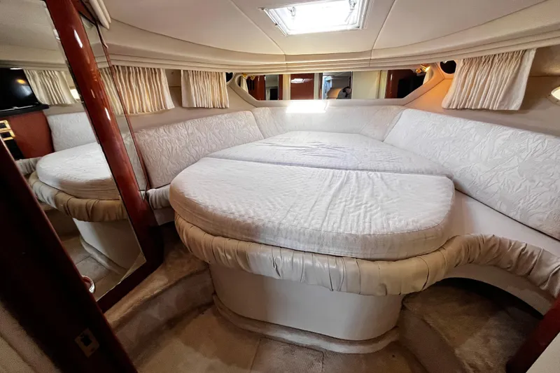 Slide: The Image of Luxurious interior cabin of a 1999 Sea Ray 380 Sundancer yacht with plush bedding. - 25