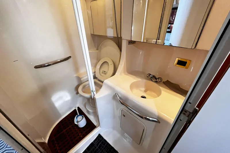 Slide: The Image of 1999 Sea Ray 380 Sundancer bathroom with shower, toilet, and sink. - 26