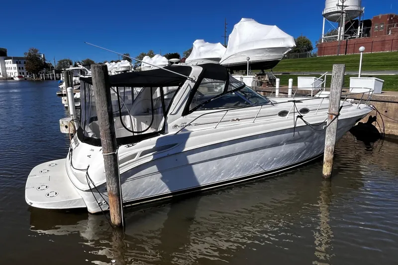 Slide: The Image of 1999 Sea Ray 380 Sundancer docked at a marina under clear blue skies. - 3