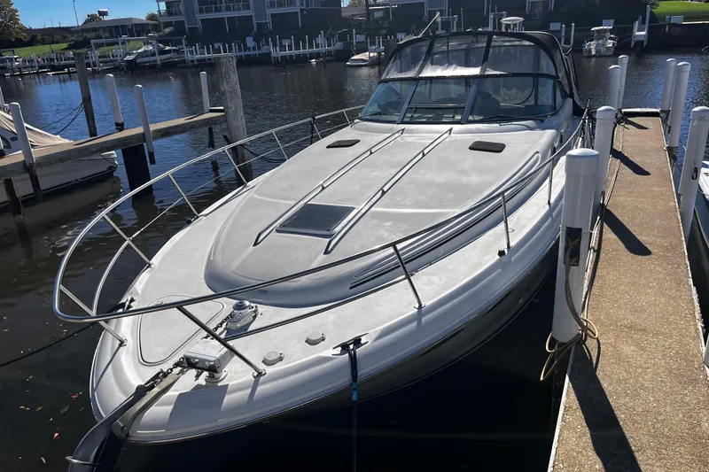 Slide: The Image of 1999 Sea Ray 380 Sundancer docked at marina, sleek design, sunny day. - 4