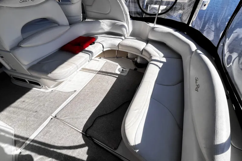 Slide: The Image of Interior of 1999 Sea Ray 380 Sundancer with white seating and carpeted floor. - 6