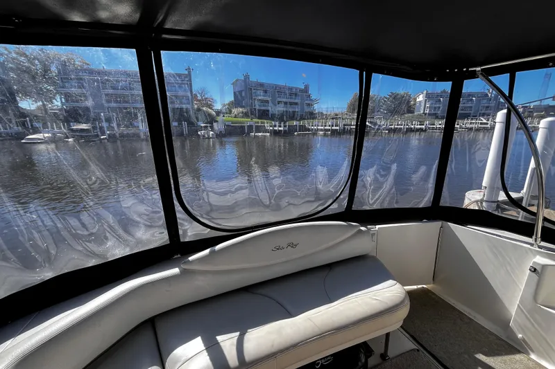 Slide: The Image of Interior view of 1999 Sea Ray 380 Sundancer with marina backdrop. - 8