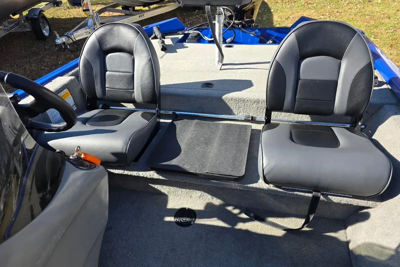 Slide: The Image of 2006 Tracker Pro Team 175 boat interior with two black seats and steering wheel. - 13