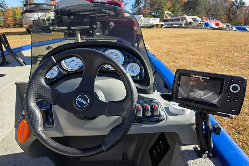 Slide: The Image of 2006 Tracker Pro Team 175 boat dashboard with steering wheel and fish finder. - 14