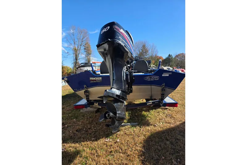 Slide: The Image of 2006 Tracker Pro Team 175 boat with outboard motor on grassy area. - 5