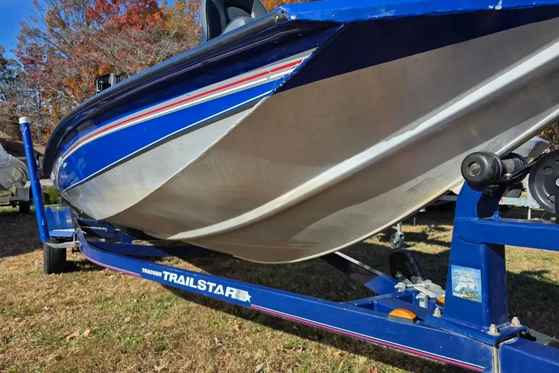 Slide: The Image of 2006 Tracker Pro Team 175 boat on a blue Trailstar trailer, parked on grass. - 6