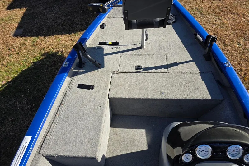 Slide: The Image of 2006 Tracker Pro Team 175 boat interior with gray carpet and blue trim. - 8