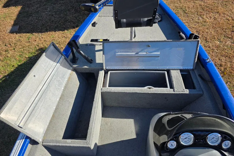 Slide: The Image of 2006 Tracker Pro Team 175 boat interior with open storage compartments and control panel. - 9