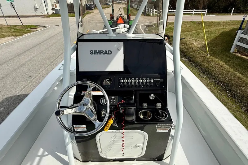 Slide: The Image of 2020 Blazer Bay 2420 GTS boat console with Simrad display and steering wheel. - 10