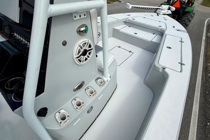 Slide: The Image of 2020 Blazer Bay 2420 GTS boat interior with fishing rod holders and storage compartments. - 14