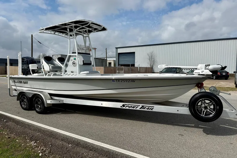 Slide: The Image of 2020 Blazer Bay 2420 GTS boat on Sport Trail trailer, parked outdoors. - 5