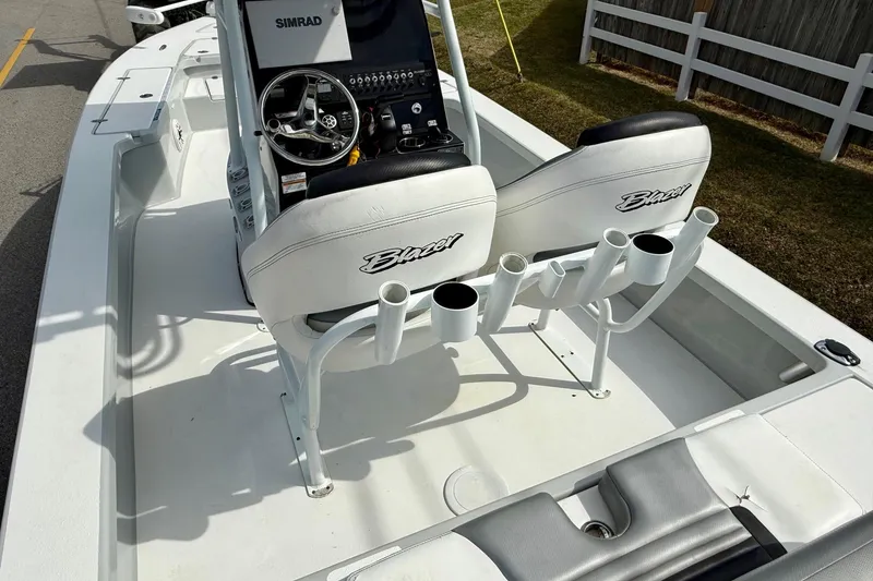 Slide: The Image of 2020 Blazer Bay 2420 GTS boat interior with steering console and rod holders. - 8