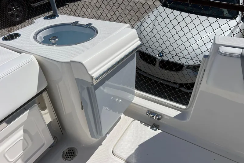 Slide: The Image of 2026 Robalo R250 Center Console boat interior with livewell and storage compartments. - 14