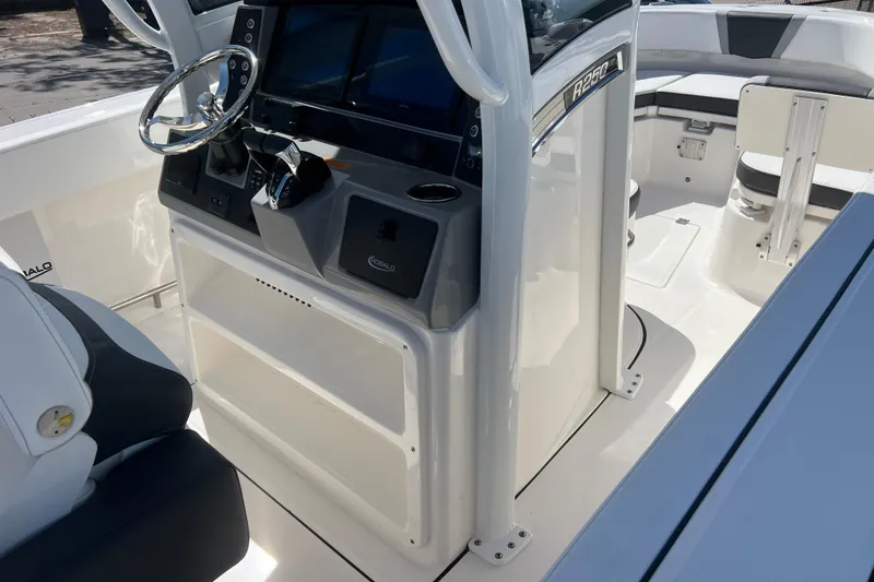 Slide: The Image of 2026 Robalo R250 Center Console boat interior with steering wheel and seating. - 4