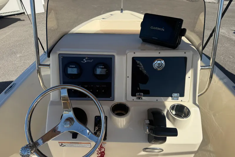 Slide: The Image of 2022 Scout 175 Sportfish boat dashboard with Garmin display and steering wheel. - 10