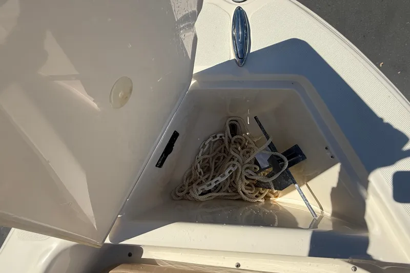 Slide: The Image of Anchor storage compartment on 2022 Scout 175 Sportfish boat, featuring rope and anchor. - 16