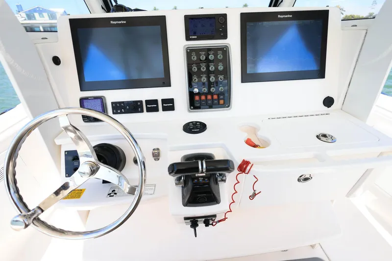 Slide: The Image of Control panel of 2015 Everglades 355 Center Console boat with dual Raymarine screens. - 14