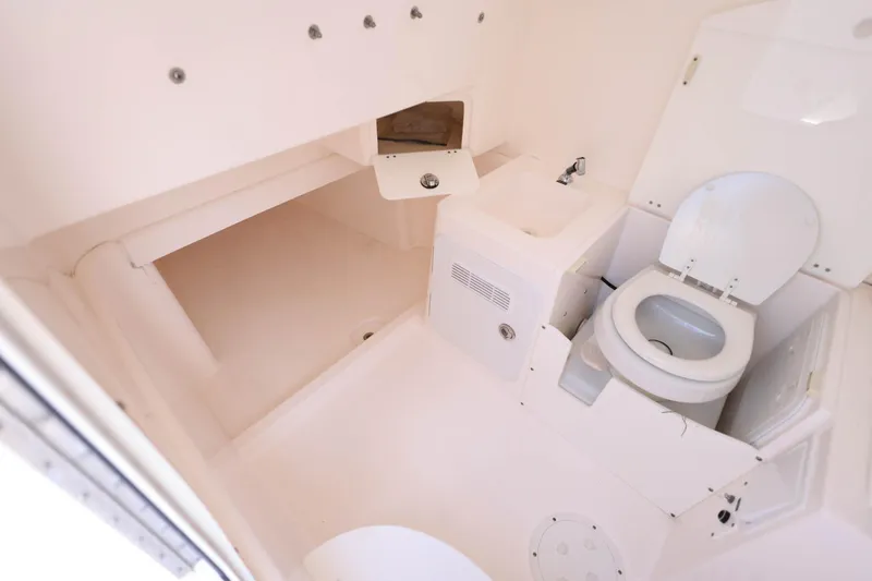Slide: The Image of Interior of 2015 Everglades 355 Center Console boat bathroom with toilet and sink. - 22