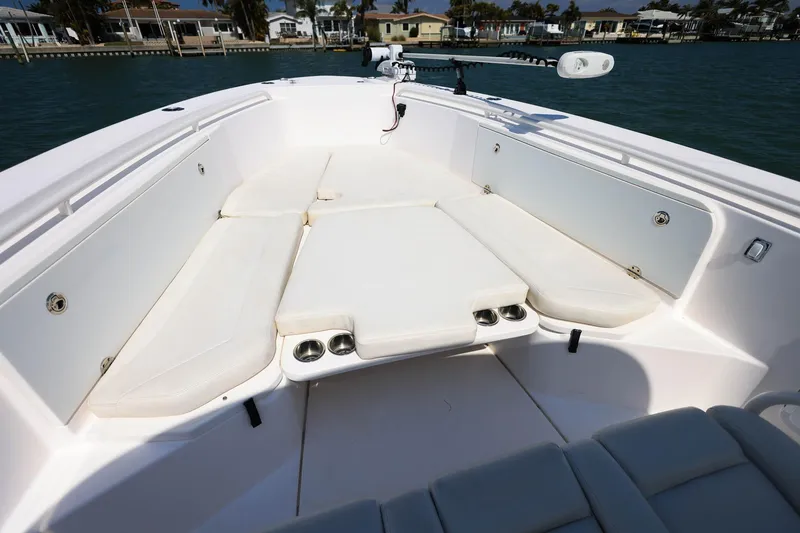 Slide: The Image of 2015 Everglades 355 Center Console boat interior with cushioned seating and cup holders. - 23
