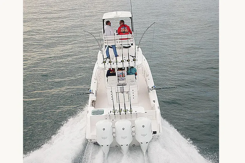 Slide: The Image of 2015 Everglades 355 Center Console boat on calm water under blue sky. - 3