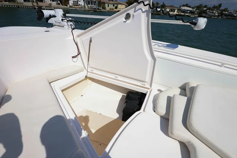 Slide: The Image of Open storage compartment on 2015 Everglades 355 Center Console boat, docked by waterfront homes. - 33