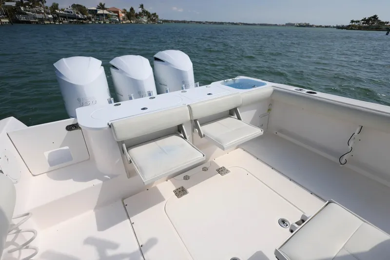 Slide: The Image of 2015 Everglades 355 Center Console boat with triple engines on open water. - 5