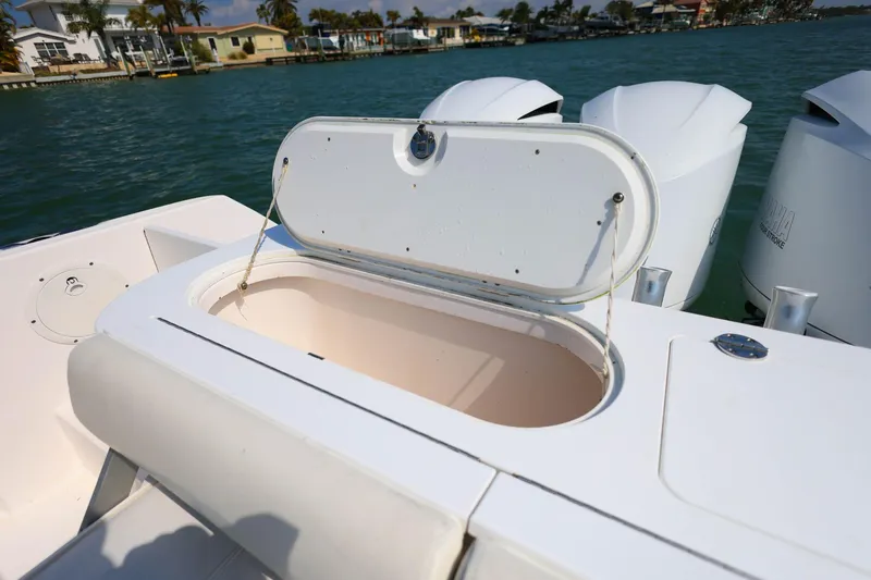 Slide: The Image of Open storage compartment on 2015 Everglades 355 Center Console boat, near outboard motors. - 9
