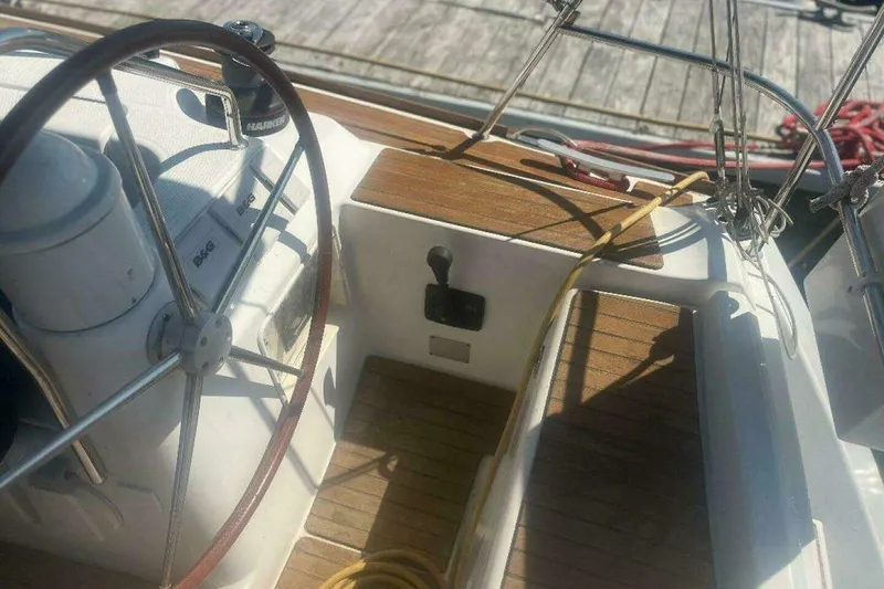 Slide: The Image of Cockpit of 2007 Jeanneau Sun Odyssey 39i sailboat with steering wheel and wooden deck. - 10