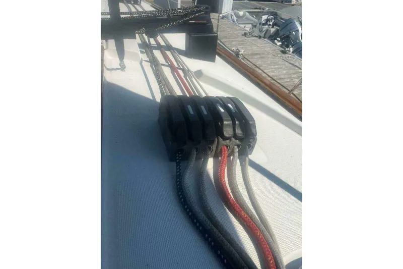 Slide: The Image of Deck rigging on a 2007 Jeanneau Sun Odyssey 39i sailboat, featuring multiple ropes and clutches. - 19